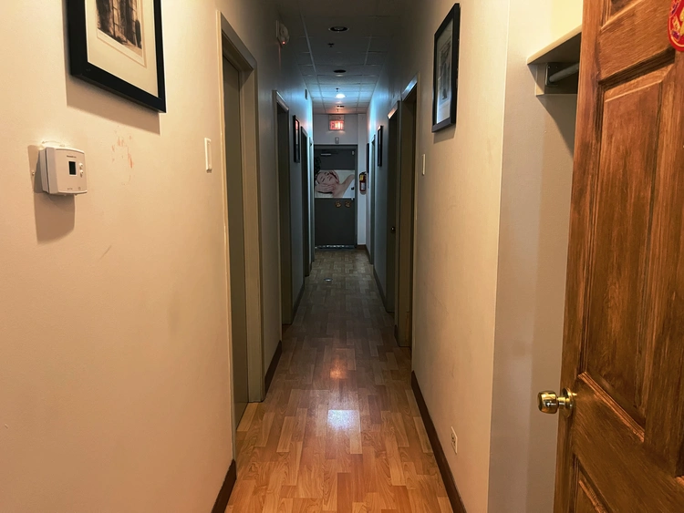 Quiet spa hallway connecting individual massage rooms